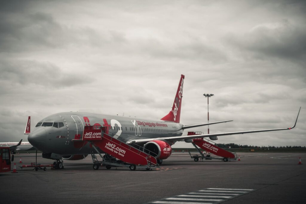 Airplane on a cloudy tarmac featuring branded Jet2 livery highlighting aviation and travel themes.